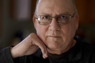 Roger Strukhoff 67, poses for a portrait Thursday, Jan. 20, 2022, in his DeKalb, Ill., home. Strukhoff was being treated for intestinal bleeding at a hospital outside Chicago this month when he suffered a mild heart attack. Normally, the medical staff would have sent Strukhoff to the intensive care unit, but, overrun with COVID-19 patients, the staff instead had to wheel a heart monitor into his room and quickly administer nitroglycerin and morphine. (AP Photo/Charles Rex Arbogast)