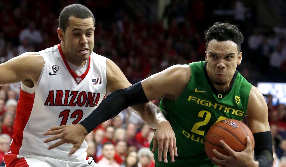 Oregon forward Dillon Brooks, right, drives past Arizona forward Ryan Anderson during the first half on Thursday.