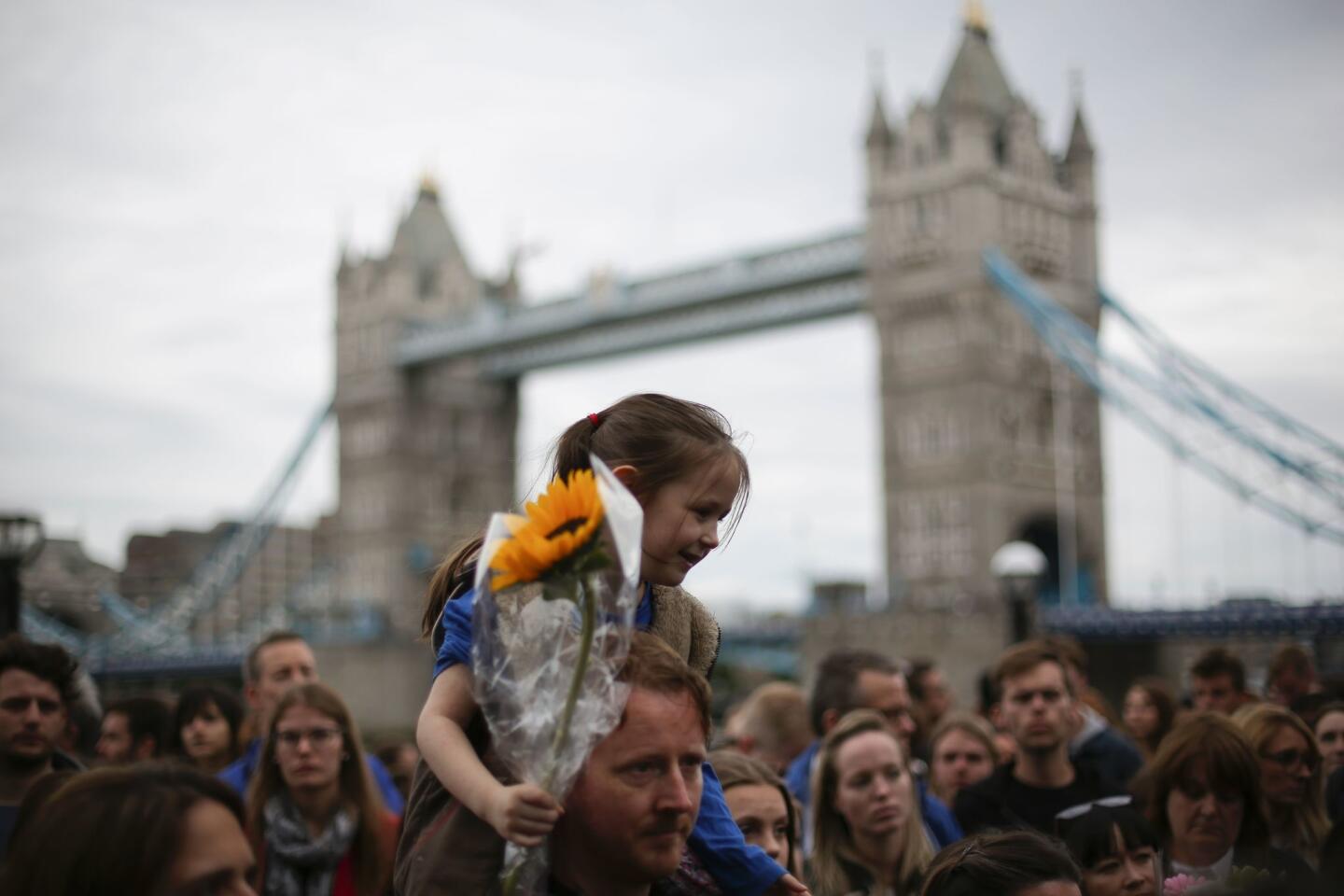 People gather for a vigil in Potters Fields Park in London on Monday to commemorate the victims of the terrorist attack on London Bridge and at Borough Market.