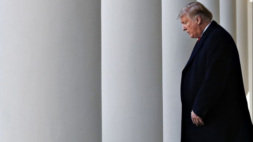 President Trump walks through the colonnade of the White House toward the Rose Garden to announce a deal to temporarily reopen the government.
