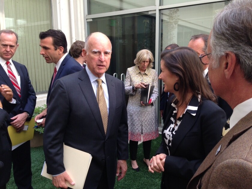 Gov. Jerry Brown speaks with California mayors on Tuesday after announcing new legislation to address the drought.