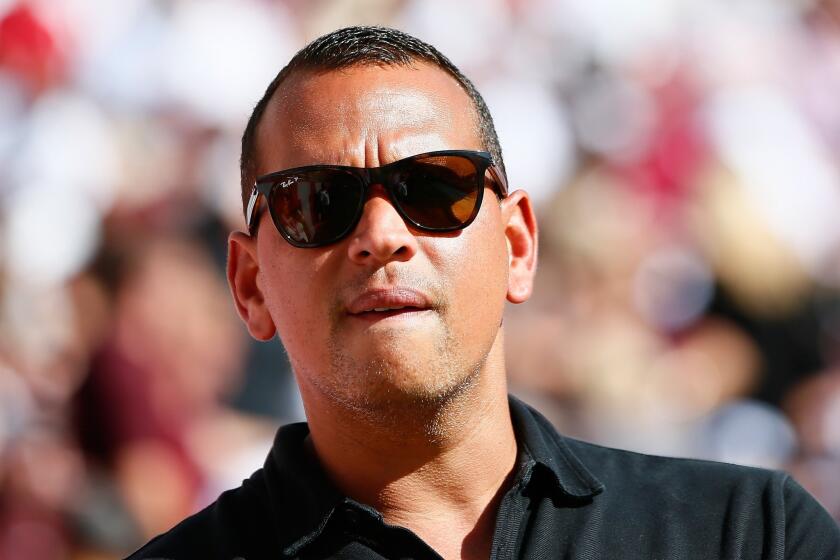 Alex Rodriguez stands on the sidelines before an Oct. 18 college football game between Alabama and Texas in Tuscaloosa, Ala.