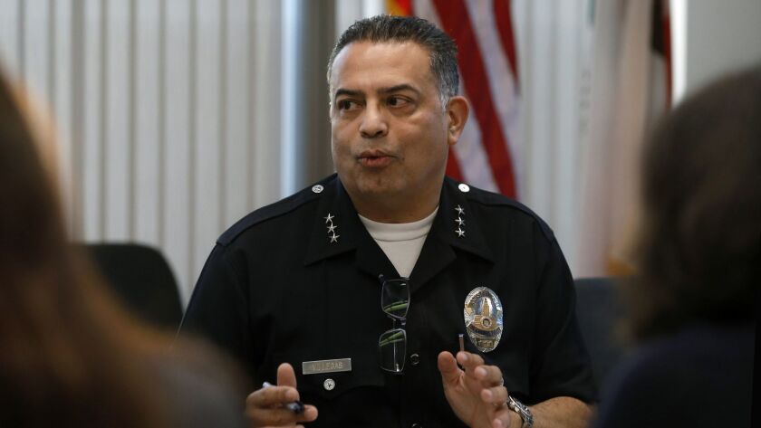 LAPD Assistant Chief Jorge Villegas' sudden retirement last month came after a department surveillance team observed him in a car engaged in a sex act with a subordinate officer, several sources told The Times.