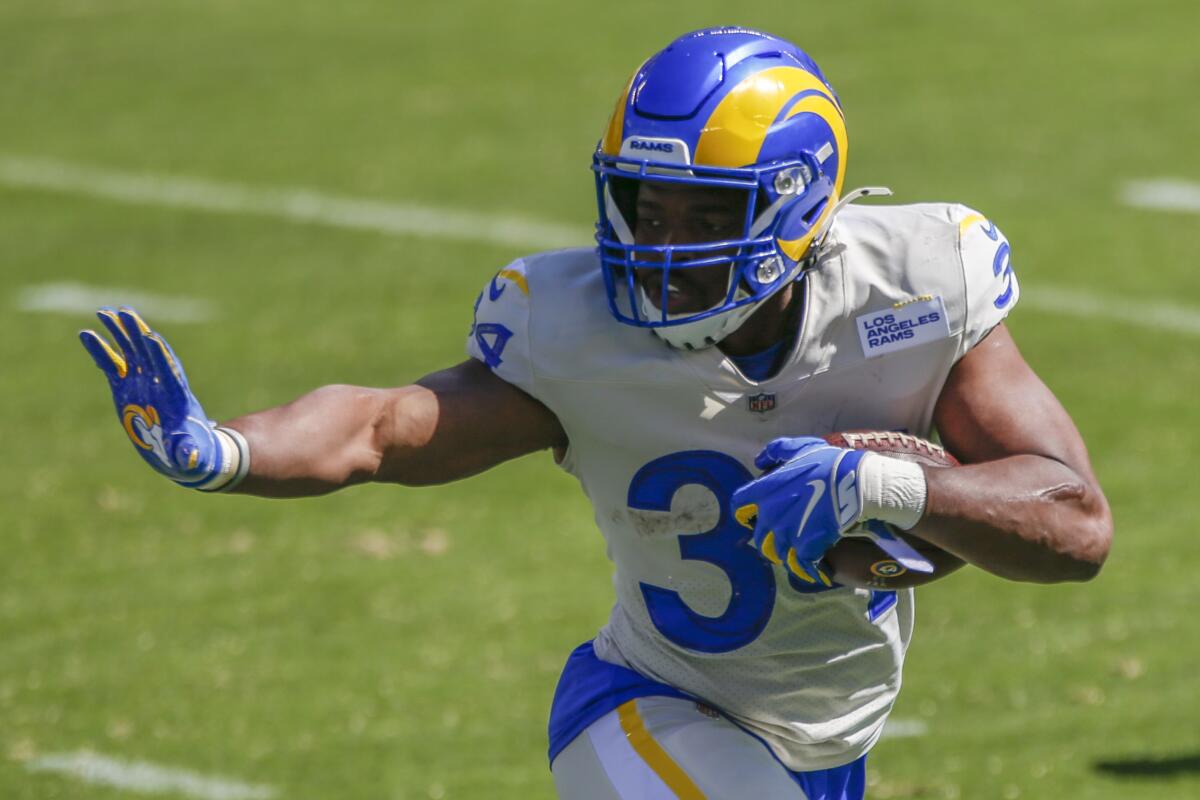 Rams running back Malcolm Brown gives a straight arm against the Eagles.