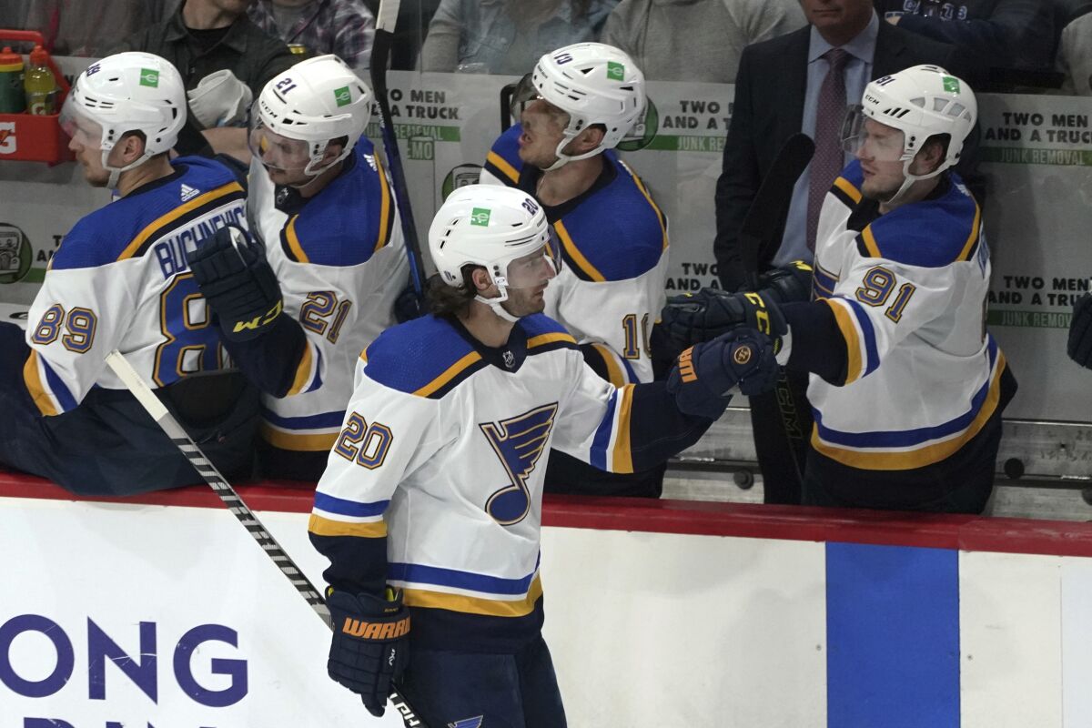 St. Louis Blues' Brandon Saad (20) gets congratulations at the bench after he scored a goal off Minnesota Wild goalie Marc-Andre Fleury (29) to tie the game in the second period of Game 5 of an NHL hockey Stanley Cup first-round playoff series, Tuesday, May 10, 2022, in St. Paul, Minn. (AP Photo/Jim Mone)