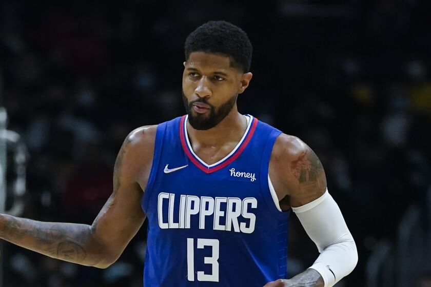 Los Angeles Clippers guard Paul George (13) controls the ball during an NBA basketball game.
