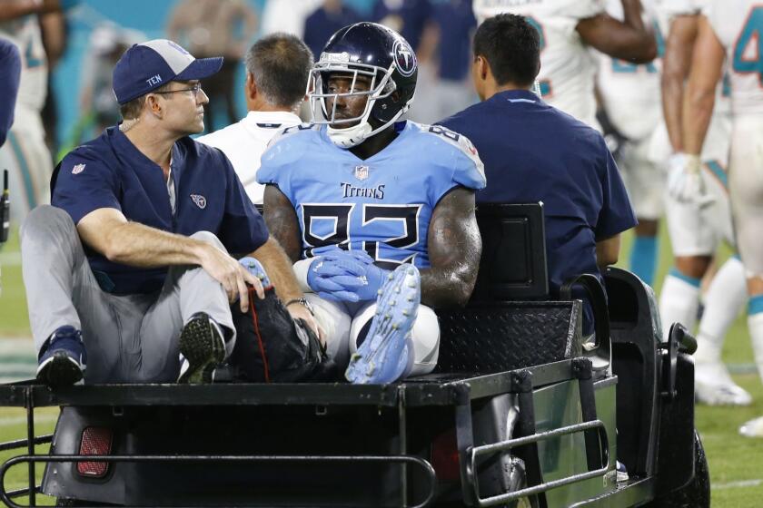 Tennessee Titans tight end Delanie Walker (82) is driven off the field after he injured his leg, during the second half of an NFL football game against the Miami Dolphins, Sunday, Sept. 9, 2018, in Miami Gardens, Fla. (AP Photo/Wilfredo Lee)