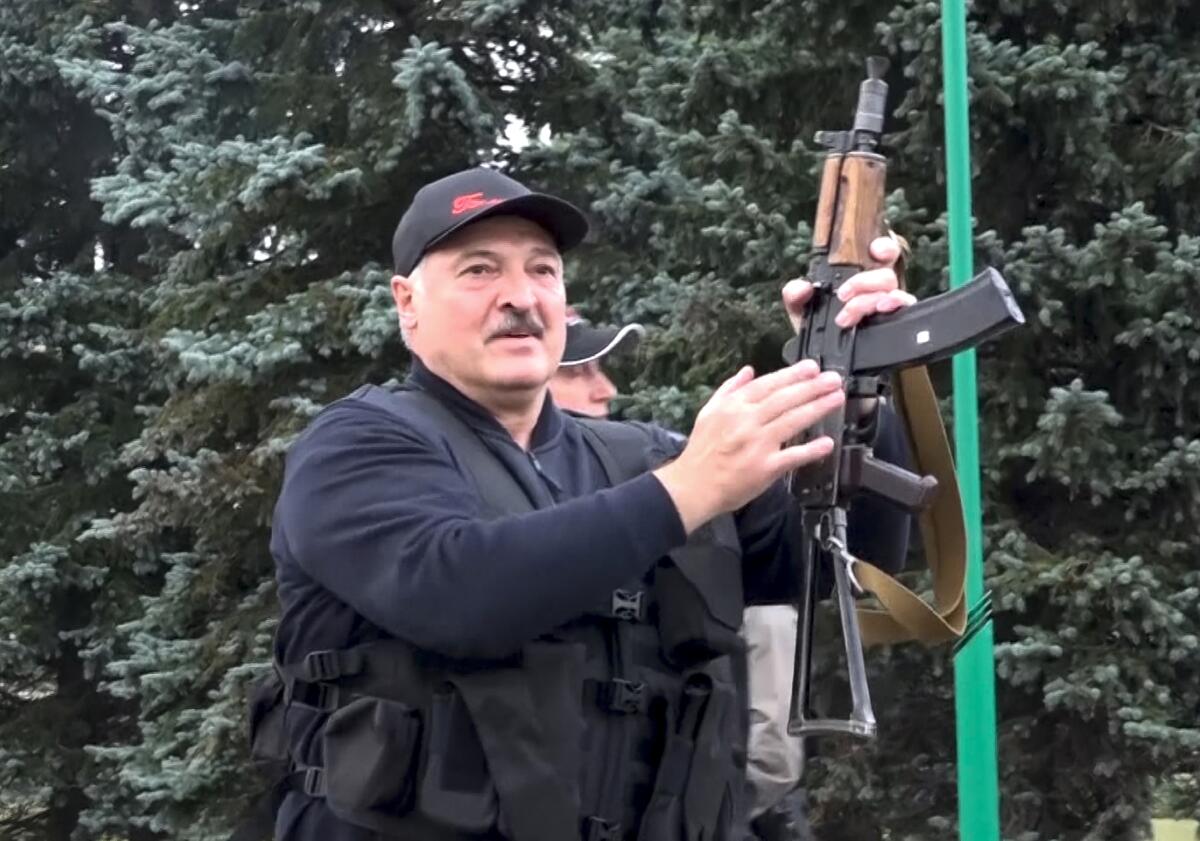 Belarus President Alexander Lukashenko armed with a Kalashnikov-type rifle
