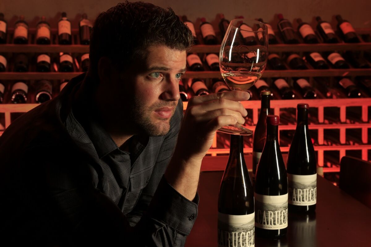 Eric Carucci, inspecting his wine at the Wine Gallery in Corona del Mar, likes to "try different things."