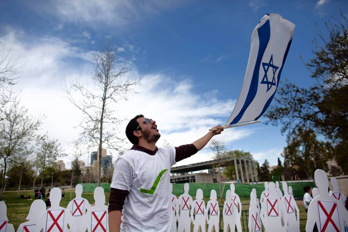 A student at Ariel University, in the West Bank Israeli settlement of Ariel, protests in front of the U.S. Consulate on Tuesday in Jerusalem before President Obama's visit.