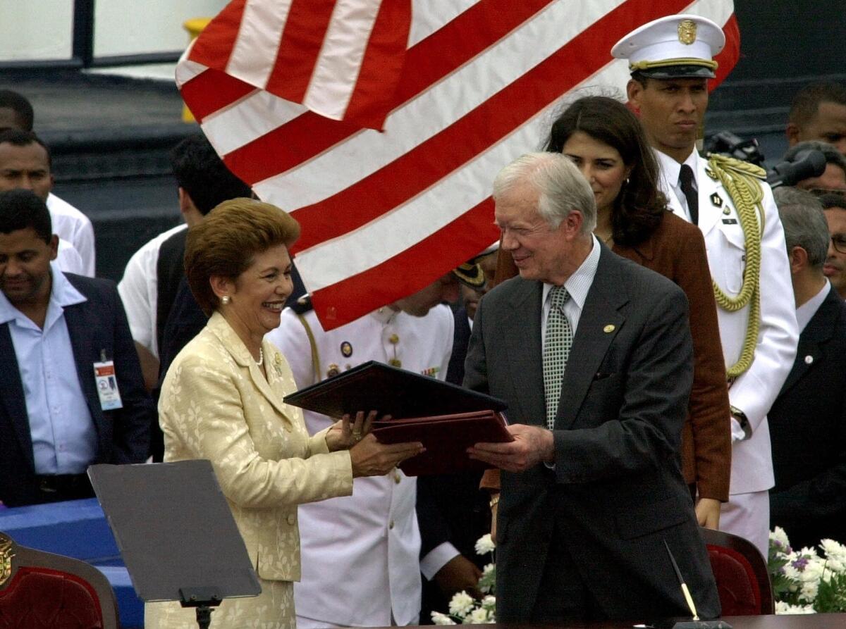 Former U.S. President Jimmy Carter with Panamanian President Mireya Moscoso during a ceremony to transfer control of the Panama Canal on Dec. 14, 1999. (Tomas Van Houtryve / Associated Press)