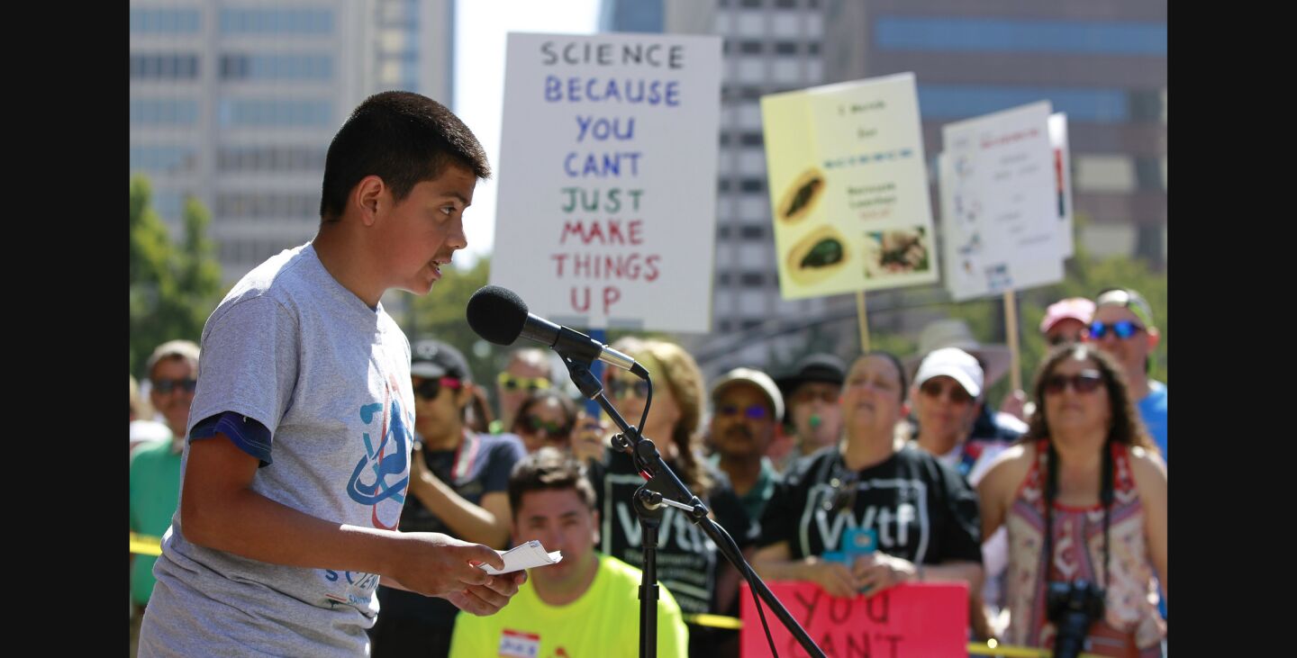 Twelve-year-old Cesar Sauceda, a seventh grader at San Marcos Middle School who says he wants to be a scientist, speaks to the crowd.