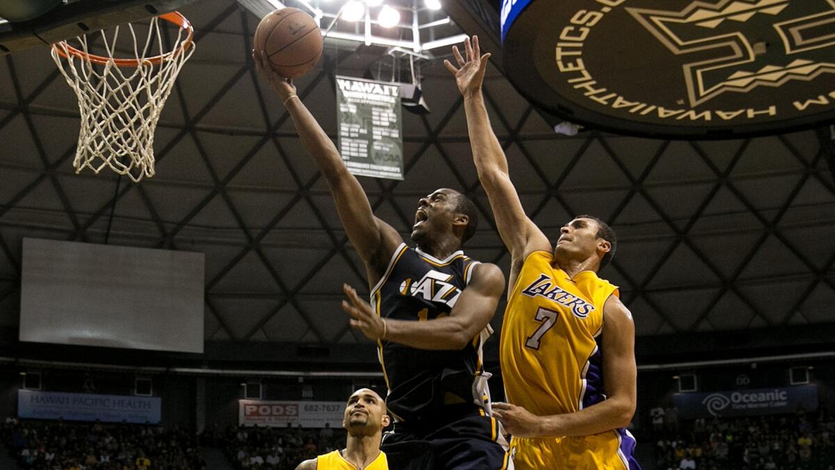 Lakers forward Larry Nance Jr. tries to block a shot by Utah Jazz guard Alec Burks during a preseason game Oct. 6 in Honolulu.