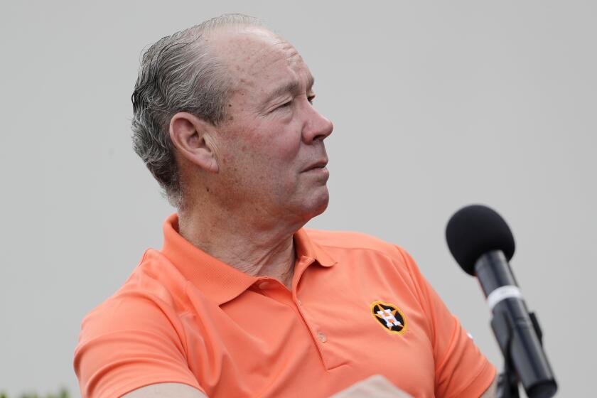 Houston Astros owner Jim Crane pauses during a news conference.