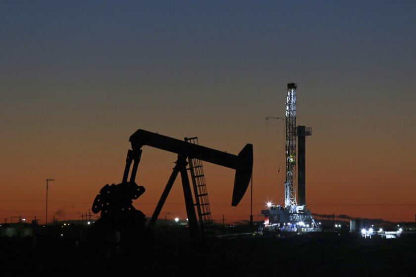 FILE- This Oct. 9, 2018, file photo shows an oil rig and pump jack in Midland, Texas. Goldman Sachs is warning of another sharp drop in oil prices, Thursday, March 26, 2020, saying some oil producers are eventually going to have to shut some wells because the coronavirus outbreak is crushing demand. (Jacob Ford/Odessa American via AP, File, File)