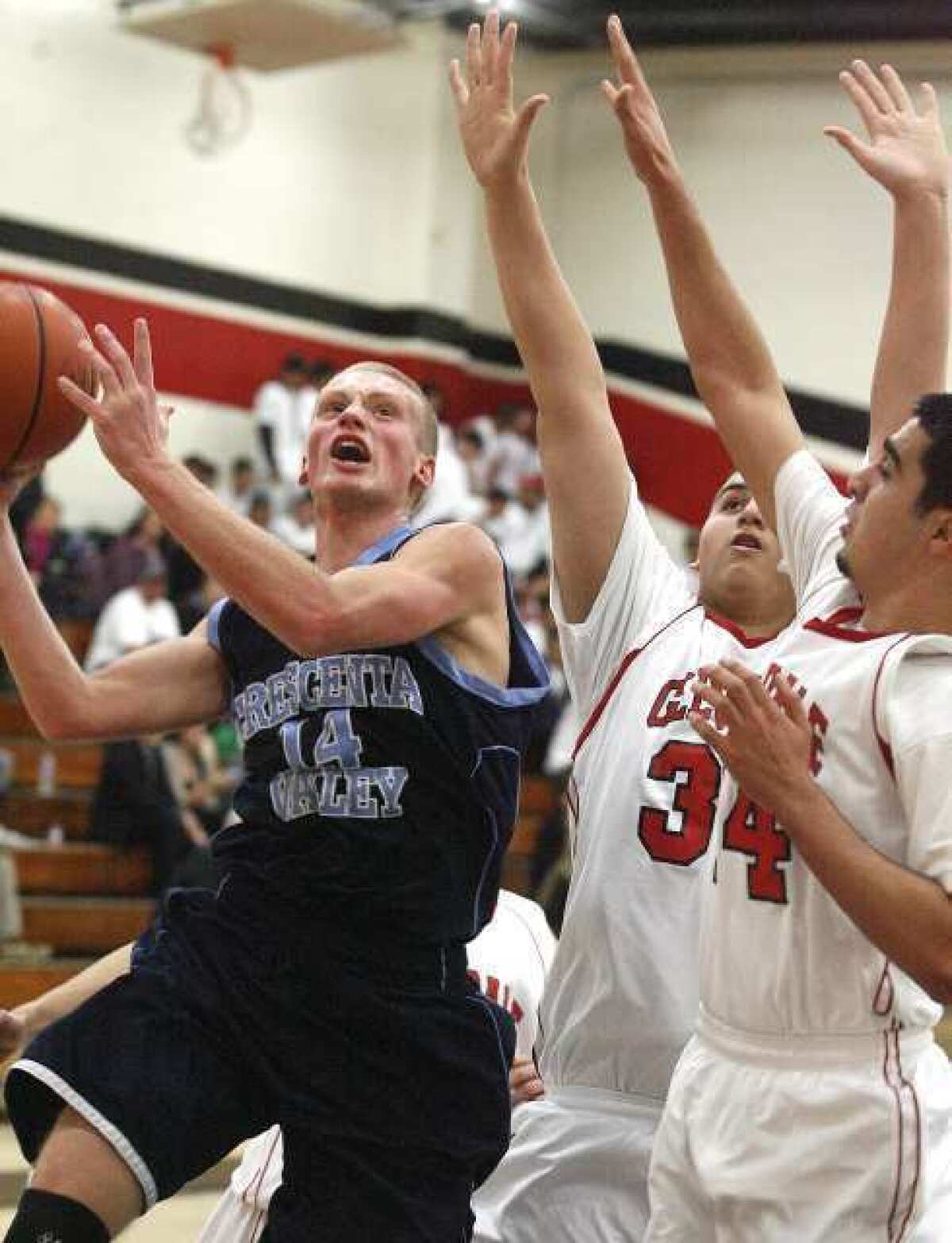 Crescenta Valley's senior guard Cole Currie, left, finished with 34 points to help the Falcons improve to 2-0 in the Pacific League.