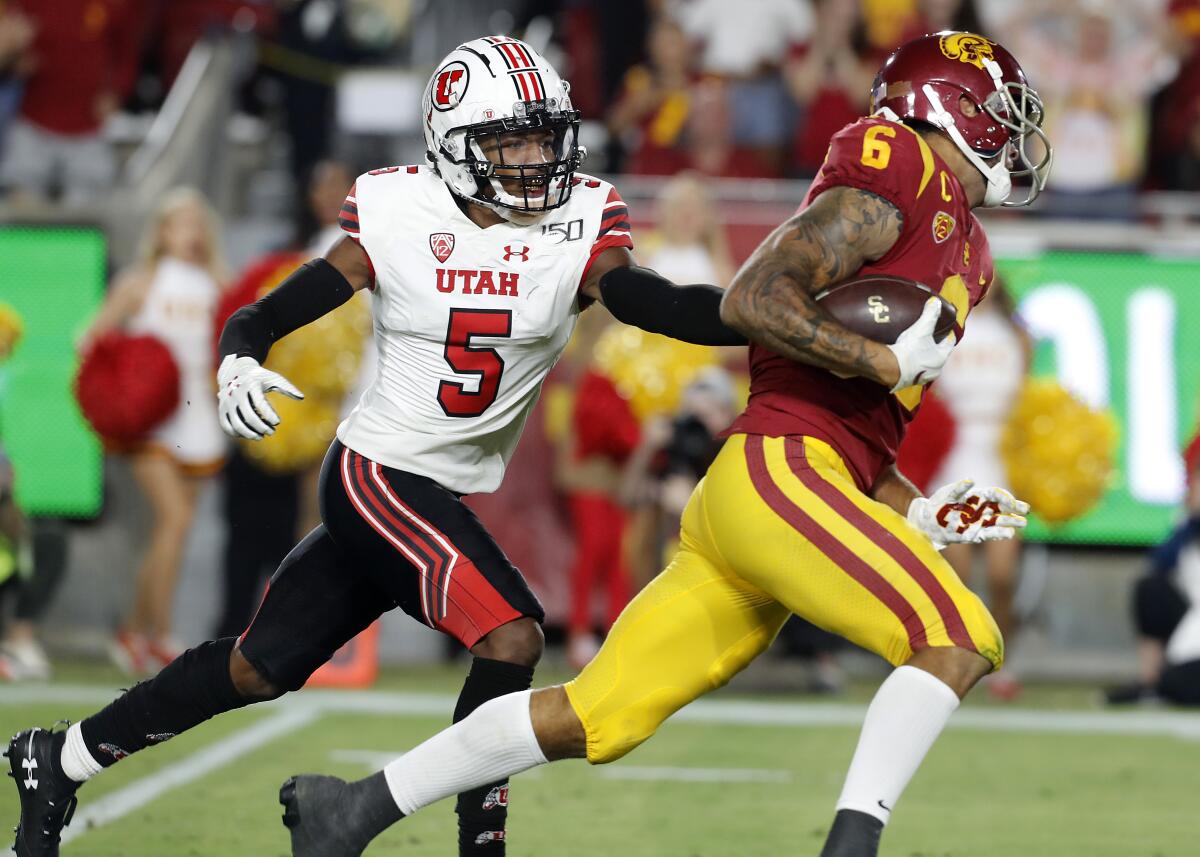 USC wide receiver Michael Pittman breaks away from Utah cornerback Tareke Lewis for a touchdown in the third quarter at the Coliseum on Friday.