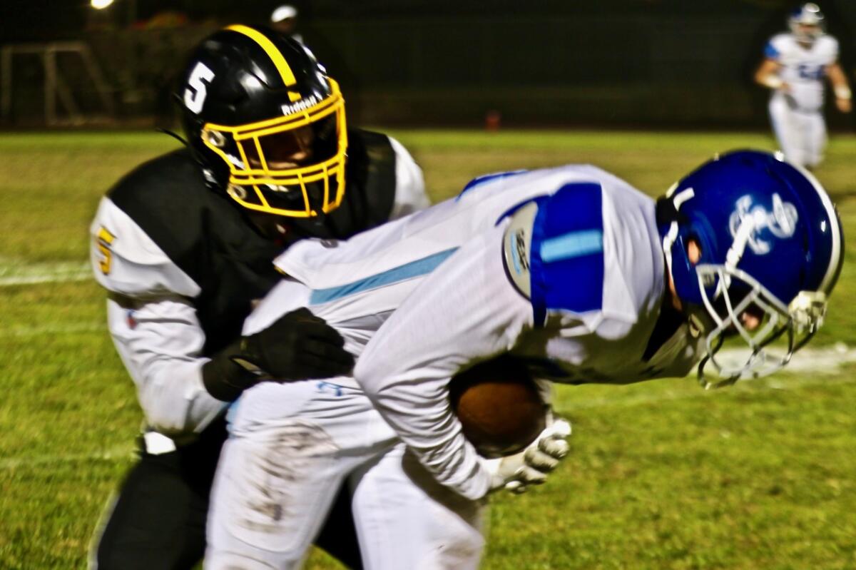 Palisades receiver Cameron Kohan is tackled by San Pedro safety Elijah Thorp in the second quarter.