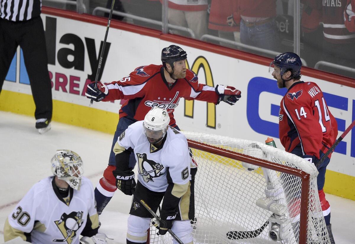 Capitals right wing Justin Williams (14) celebrates his goal with teammate Jason Chimera during the second period of Game 5 against the Penguins on Saturday.