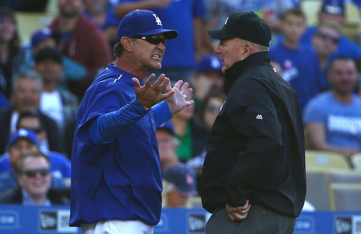 Dodgers Manager Don Mattingly argues with third base umpire Bob Davidson in the fourth inning. Mattingly was subsequently ejected for his dispute of the call.