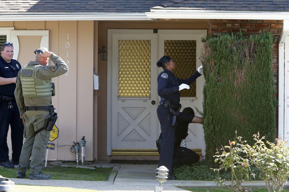 HBPD investigators search the yard of a home on Constitution Drive for evidence Thursday, March 17, 2022.