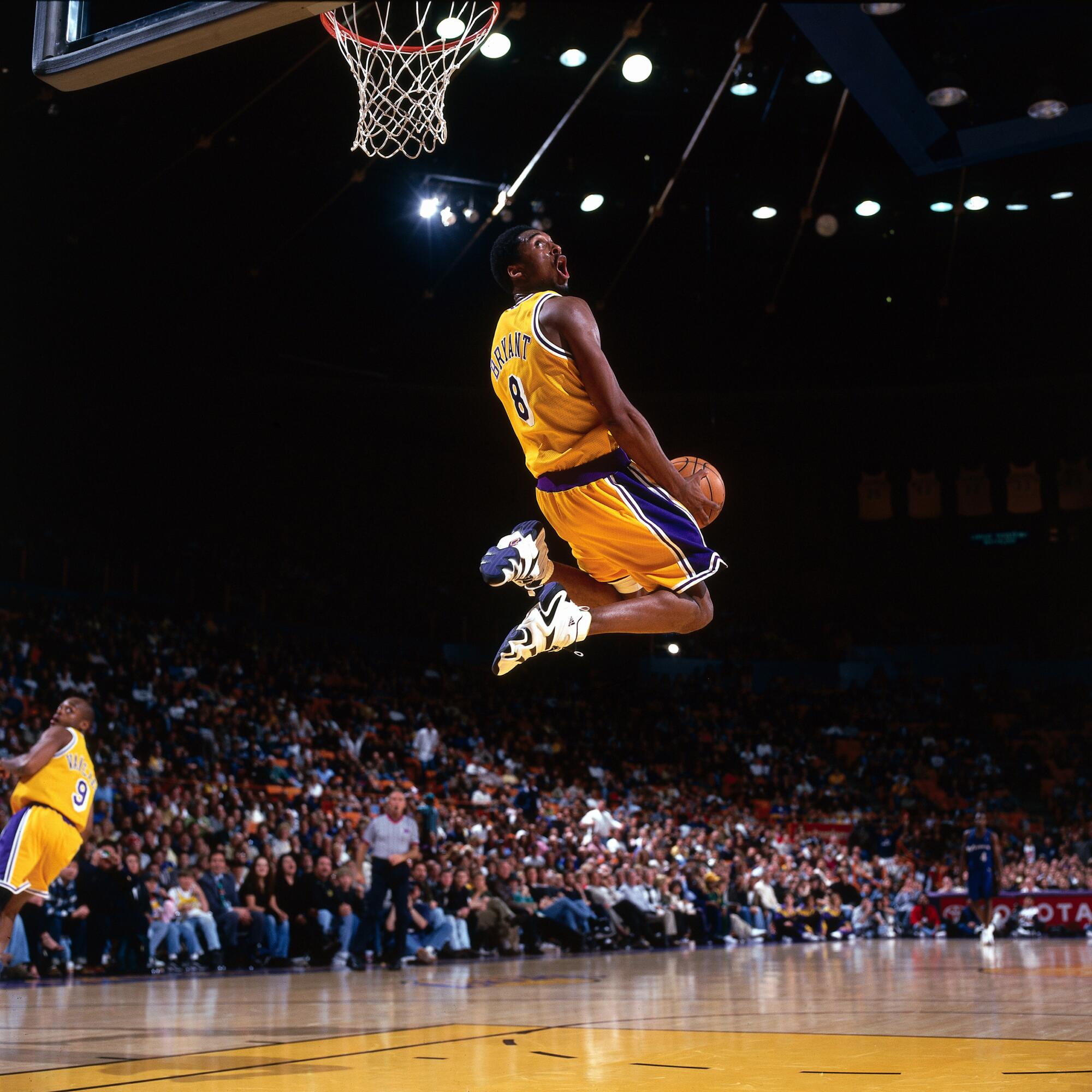 Kobe Bryant soars for a reverse dunk.