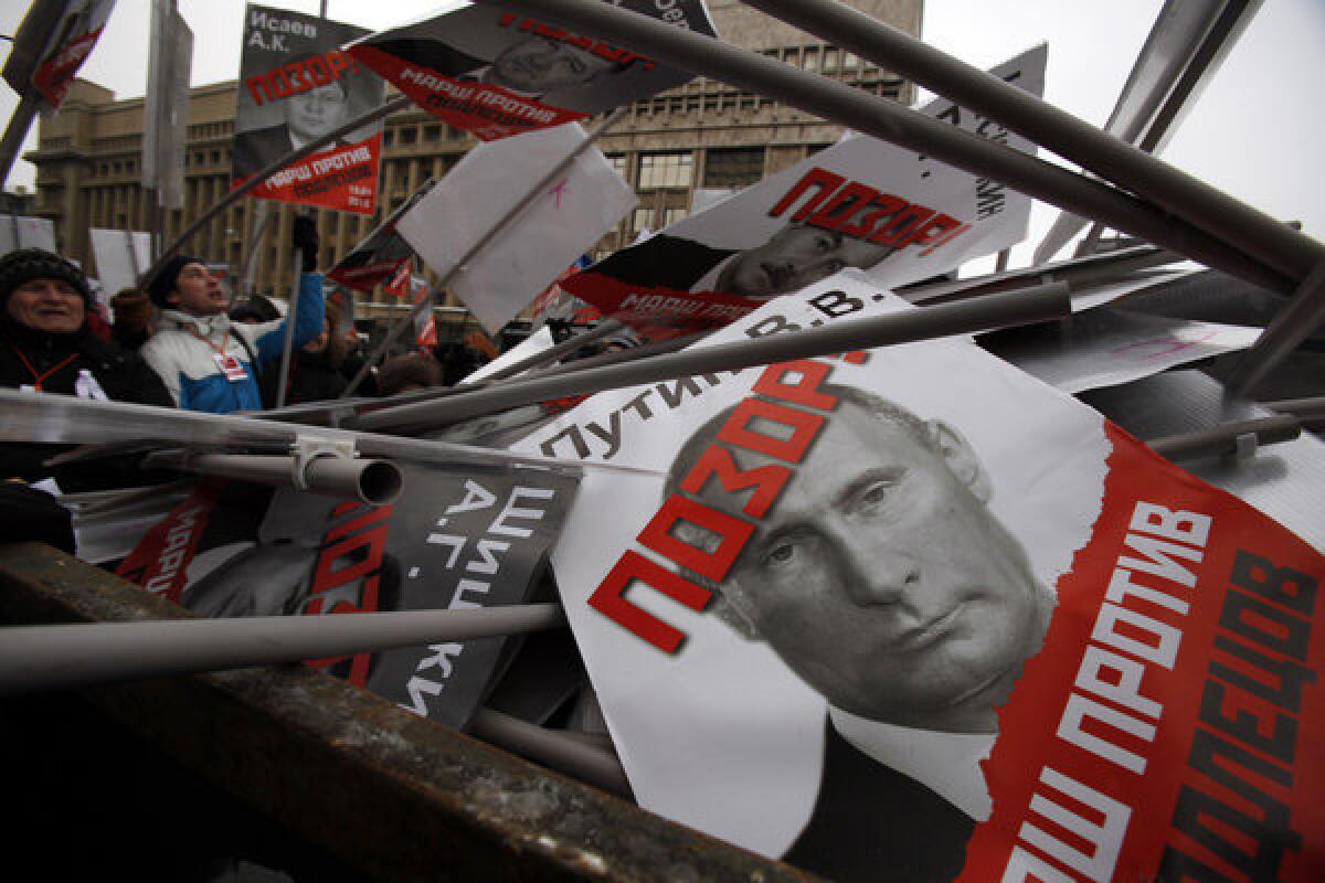 Thousands of demonstrators opposed to a law banning U.S. families from adopting Russian orphans took to the streets of Moscow with signs showing President Vladimir Putin and other politicians who supported the law with "Shame" written on their faces.