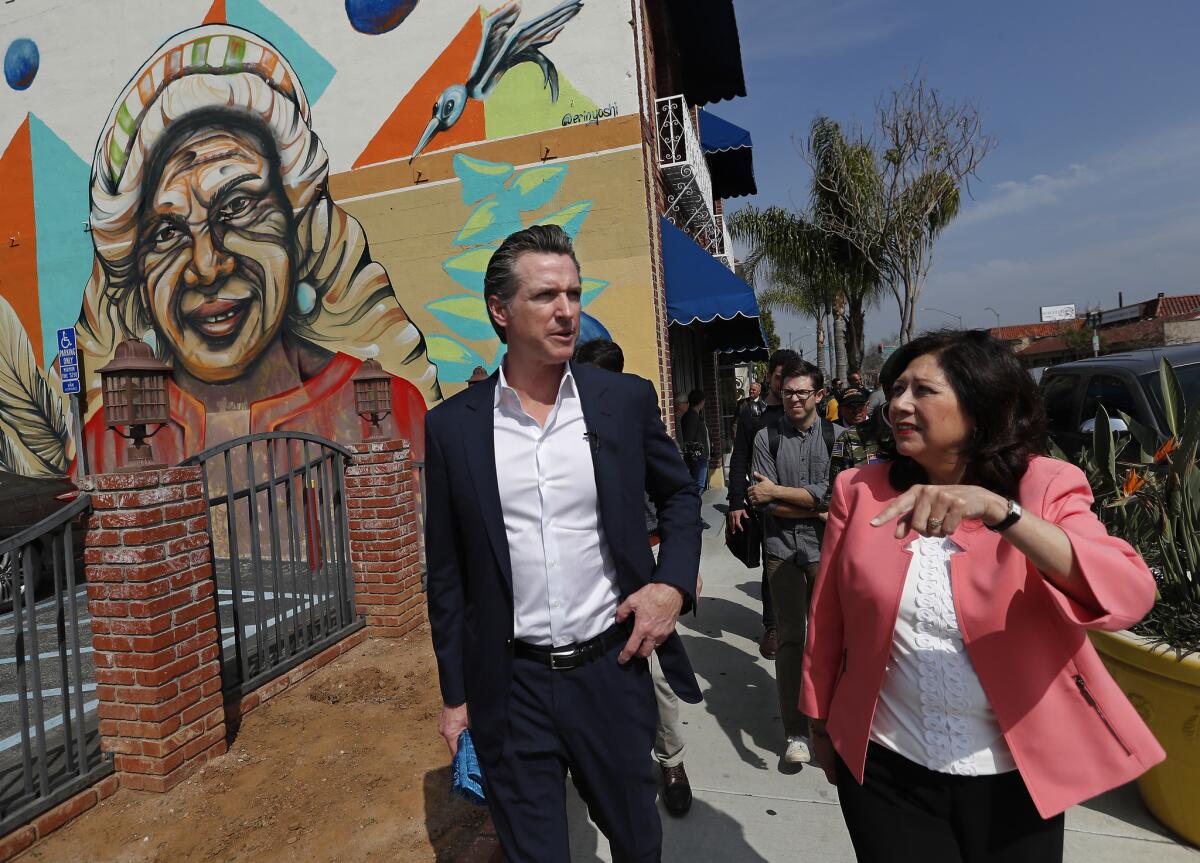 Los Angeles County Supervisor Hilda Solis walks with Lt. Gov. Gavin Newsom before announcing that she is endorsing him for governor.