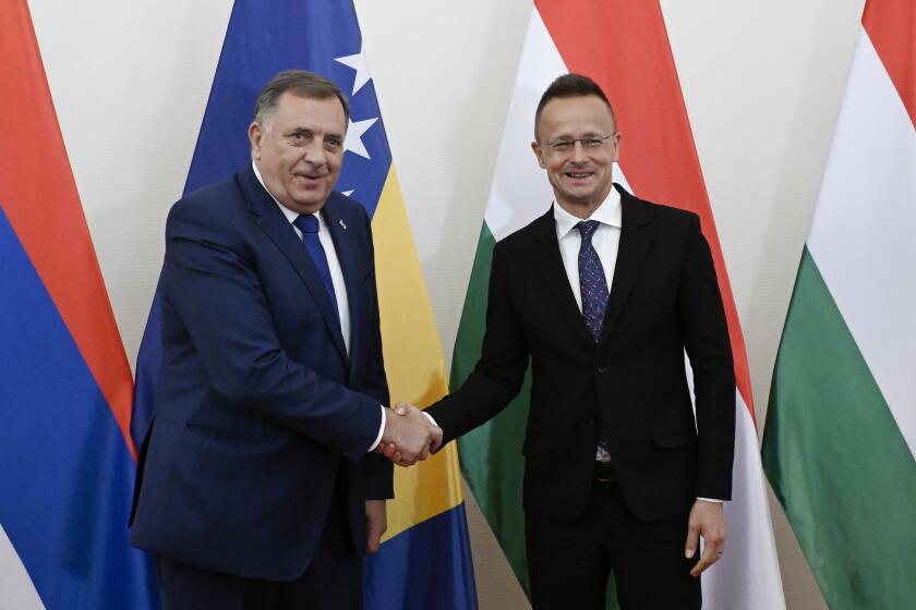 Hungarian Minister of Foreign Affairs and Trade Peter Szijjarto, right, receives Bosnian Serb leader serving as the 8th President of Republika Srpska, Milorad Dodik in his office office in Budapest, Hungary, Wednesday, May 15, 2024. (Szilard Koszticsak/MTI via AP)