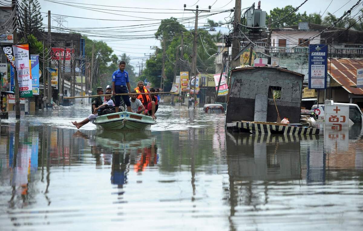 Sri Lankan navy and army personnel evacuate residents after flooding in the Kolonnawa suburb of Colombo.