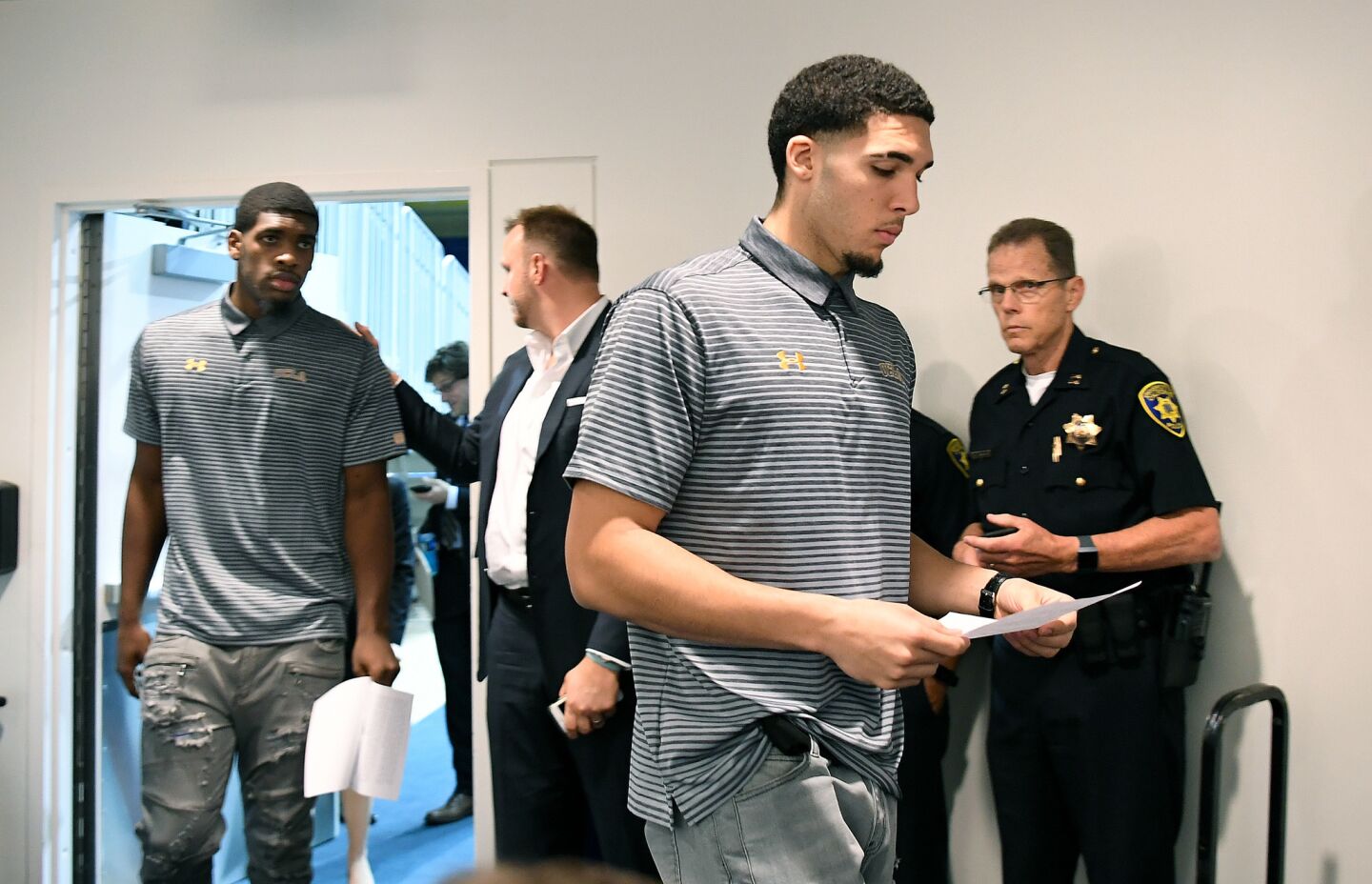 UCLA basketball players Cody Riley, left, and LiAngelo Ball arrive for a press conference at Pauley Pavilion.