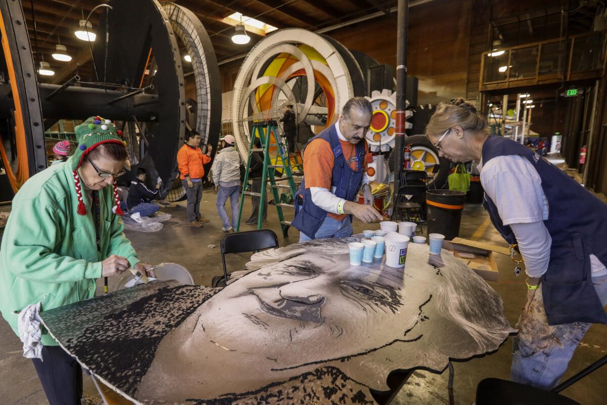 A group of volunteers work on the Amazon float at Paradiso Parade Floats in Pasadena.