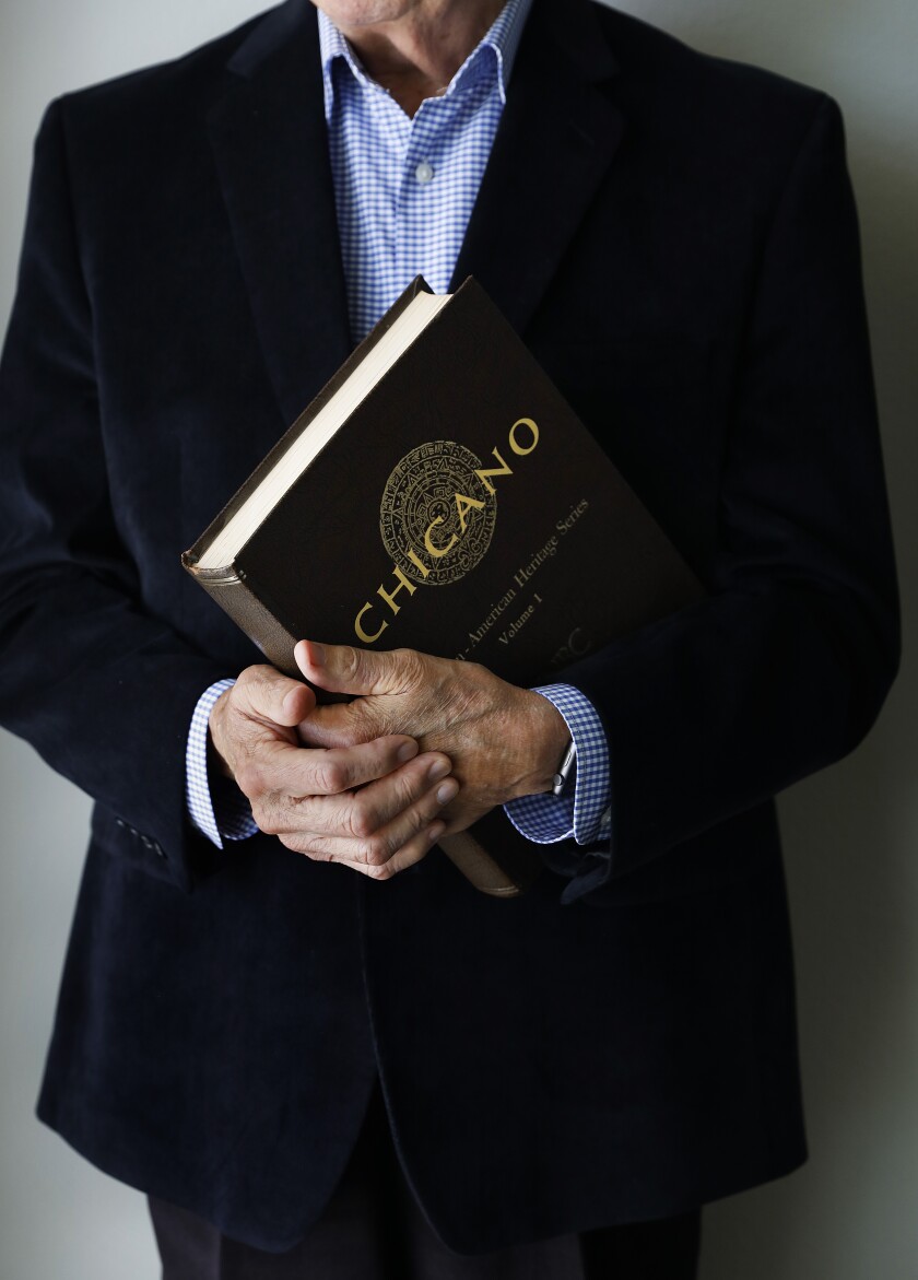 A close-up of hands holding scripts of the second volume of "Chicano I & II" 