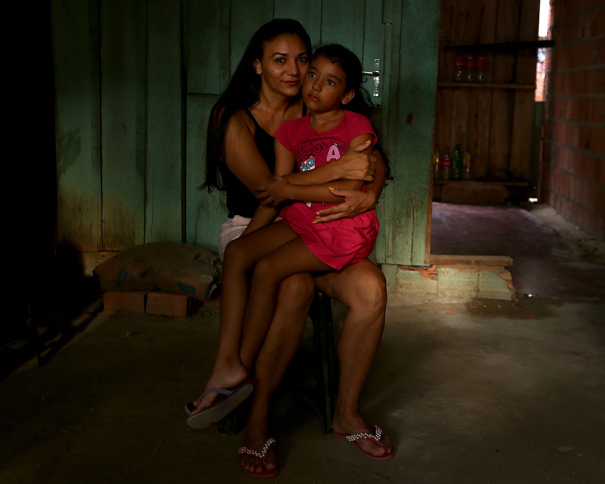 Ludernilce Peixoto Costa, 43, embraces her daughter Adrielly, 6, at their home on the outskirts of Manaus, Brazil.