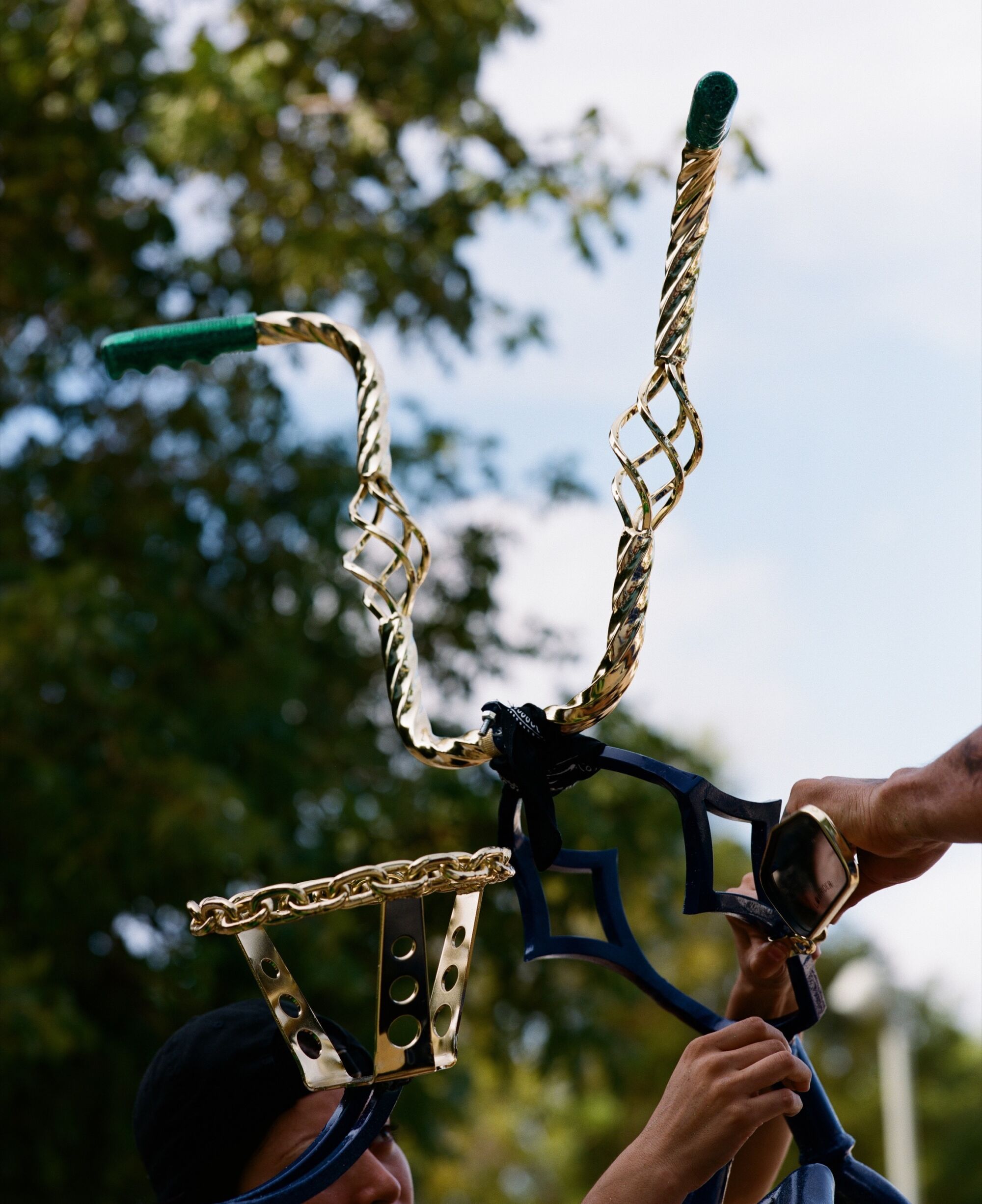 Photo of golden handlebars. 