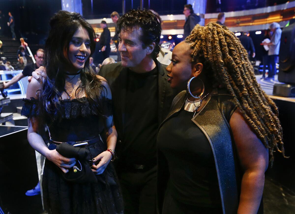 Scott Borchetta, the in-house mentor for "American Idol" and founder of Big Machine Records, talks with contestants Sonika Vaid, left, and La'Porsha Renae, right, at the end of a dress rehearsal for the show at CBS Television City in Hollywood, on March 24, 2016. This is the last year of the landmark series. (Mel Melcon/Los Angeles Times)