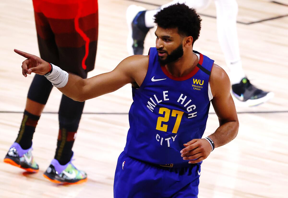The Nuggets' Jamal Murray reacts after a three-pointer against the Jazz during double overtime Aug. 8, 2020.