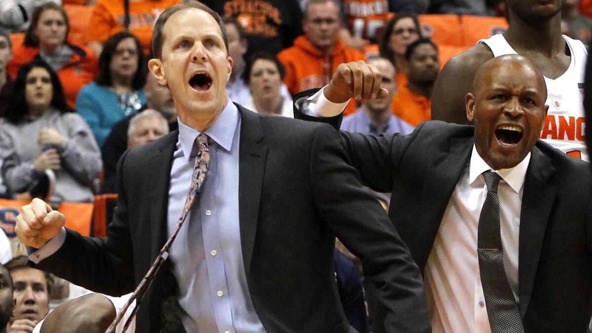 Mike Hopkins, left, and fellow assistant coach Adrian Autry celebrate in the final seconds of Syracuse's win over Wake Forest on Jan. 24.