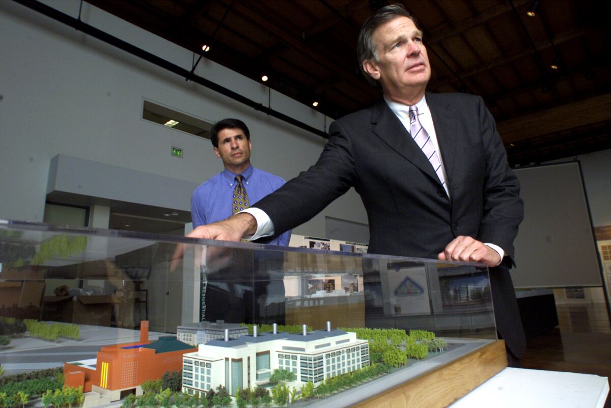 A man shows a mockup site of a building