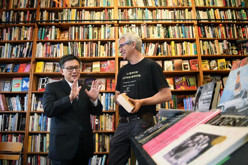 LOS ANGELES-CA-JUNE 6, 2017: Gubernatorial candidate John Chiang, left, visits with David Kipen at his lending library, Libros Schmibros, in Boyle Heights on Tuesday, June 6, 2017. (Christina House / For The Times)