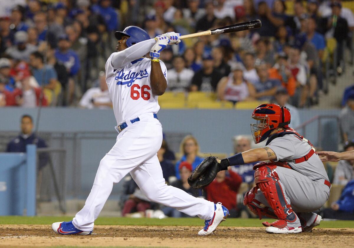 Dodgers outfielder Yasiel Puig follows through on a solo home run in the sixth inning against the Cardinals on May 13.