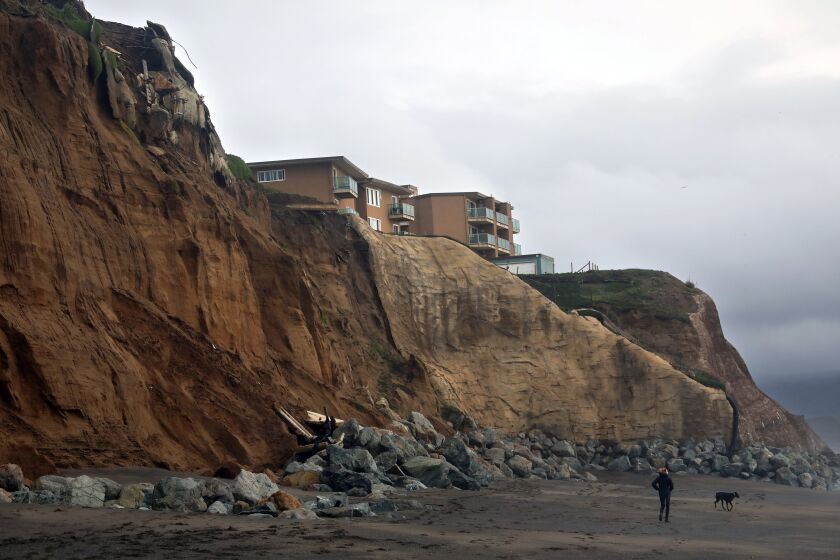 Carolyn Cole  Los Angeles Times WHAT’S LEFT of an apartment building hangs over a cliff in Pacifica, Calif. The state and the U.N. are expected to work with insurers, researchers and risk management experts to address climate change issues such as wildfires, sea level rise and coastal erosion.