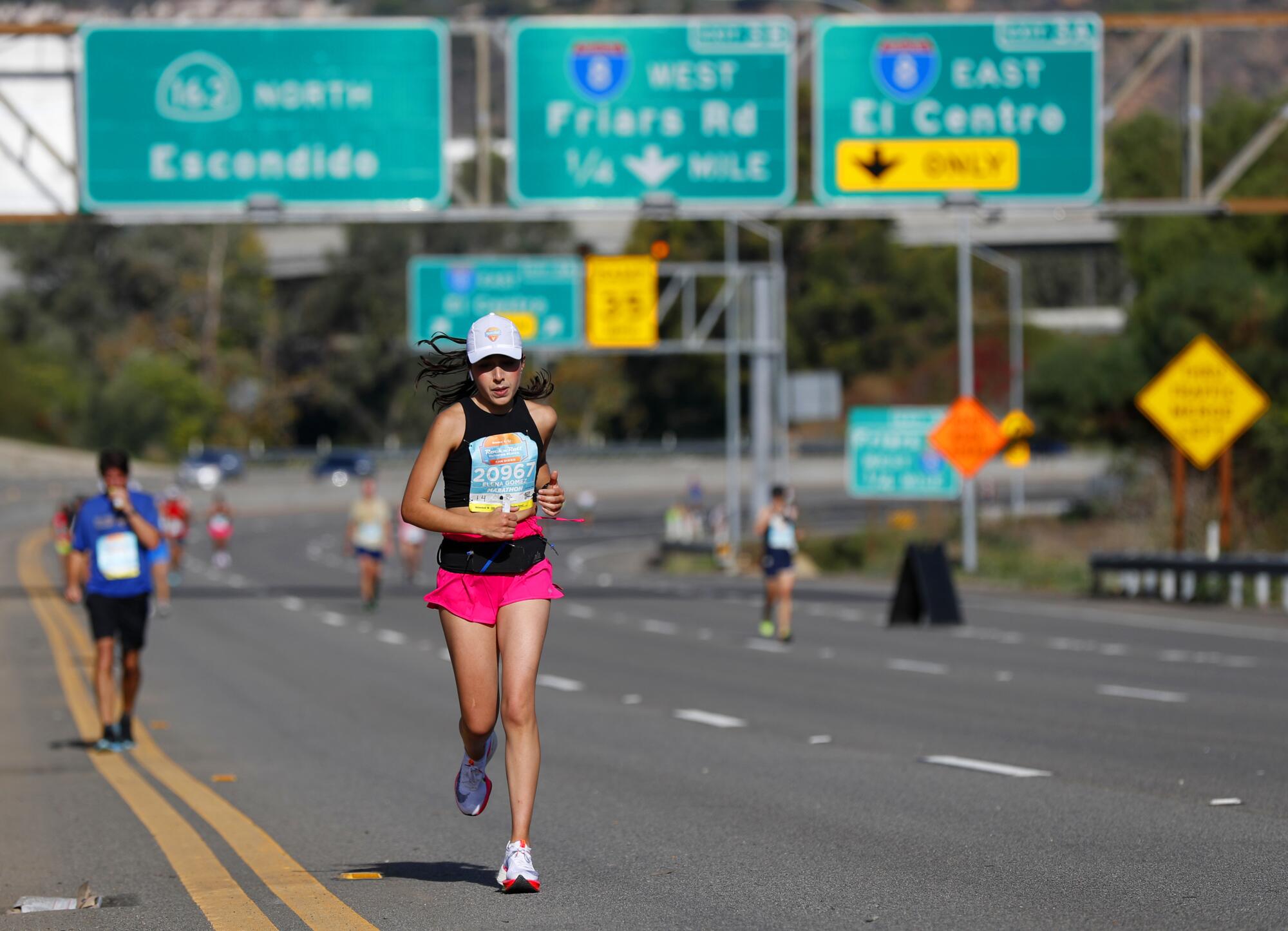 Runners in the marathon portion of the Rock 'n' Roll Marathon and Half run on State Route 163 in Mission Valley  Sunday.