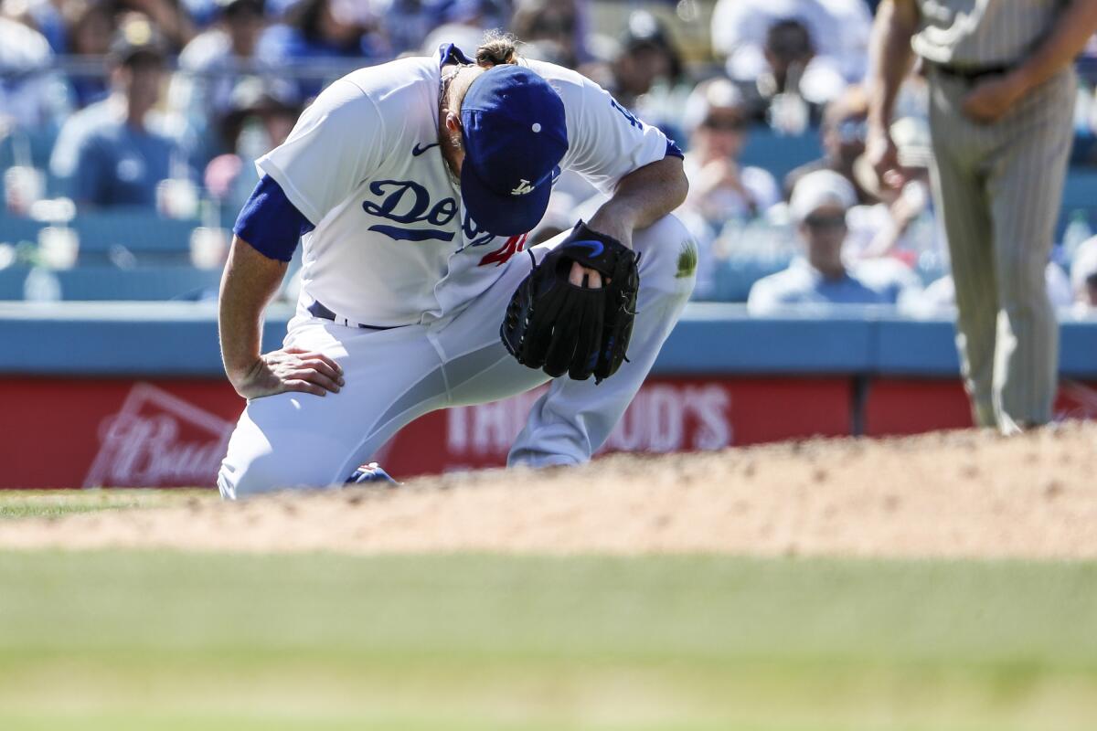 Dodgers relief pitcher Craig Kimbrel gathers his composure after being hit by a line drive against the Padres Sunday