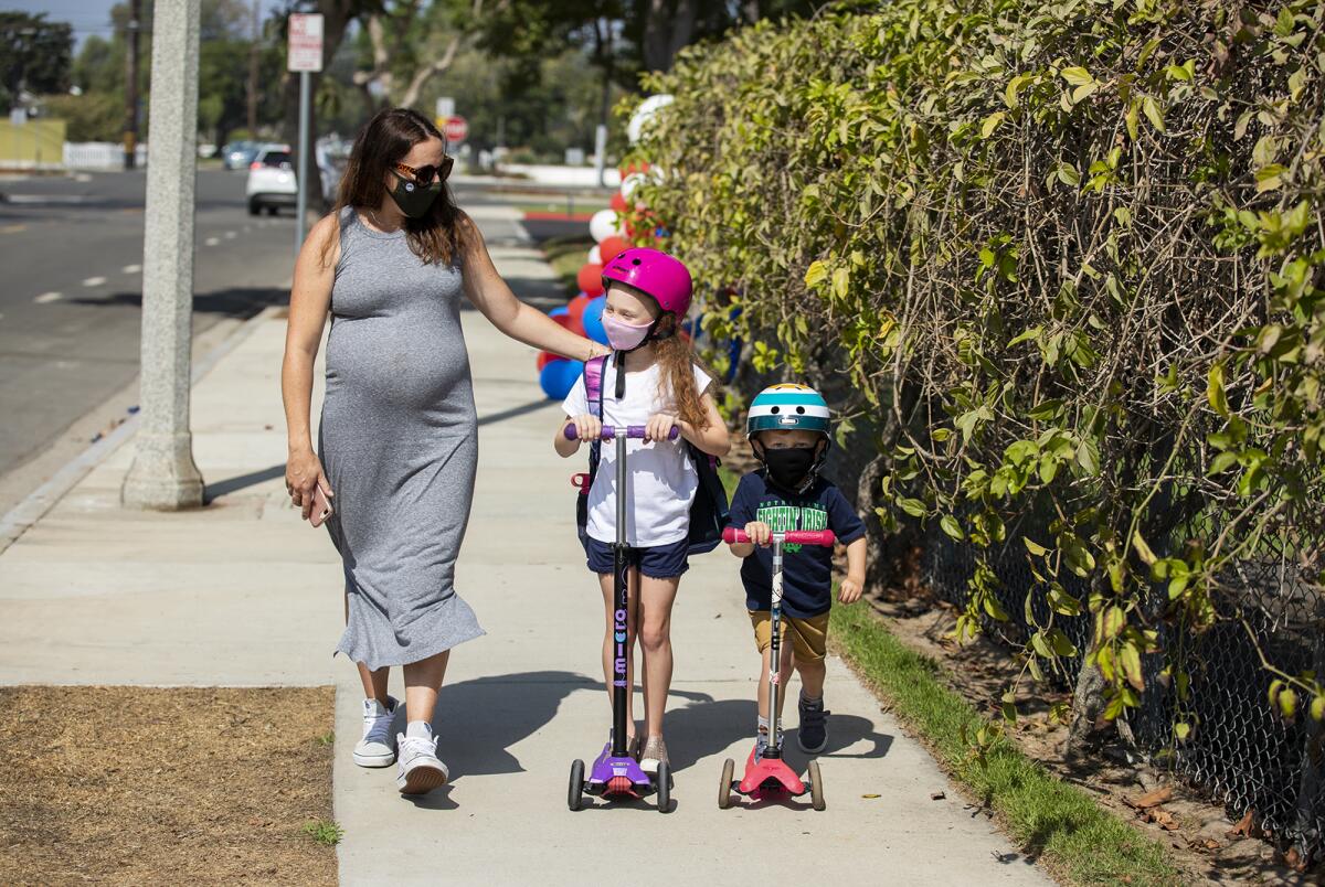 Danielle Hodge, left, walks with her daugther Isla, 6, and son Declan, 4, 