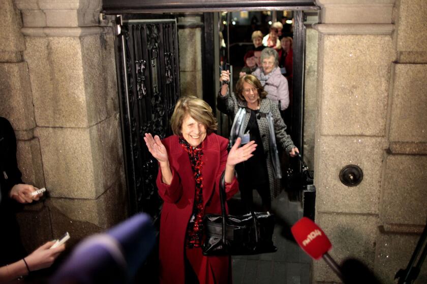 Kathleen Janette, who worked at the Catholic-run workhouses known as the Magdalen laundries, reacts along with other women after leaving the Irish Parliament building in Dublin on Tuesday.