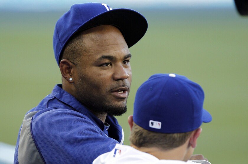 Dodgers left fielder Carl Crawford chats with catcher Tim Federowicz before a game against the White Sox last week.