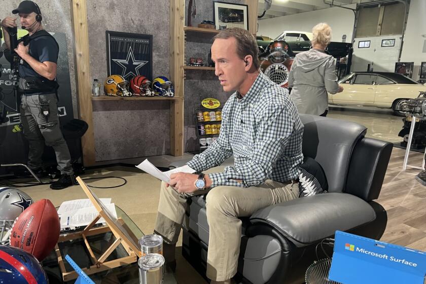 Peyton Manning works in his makeshift studio in a friend's vintage car garage in Denver.