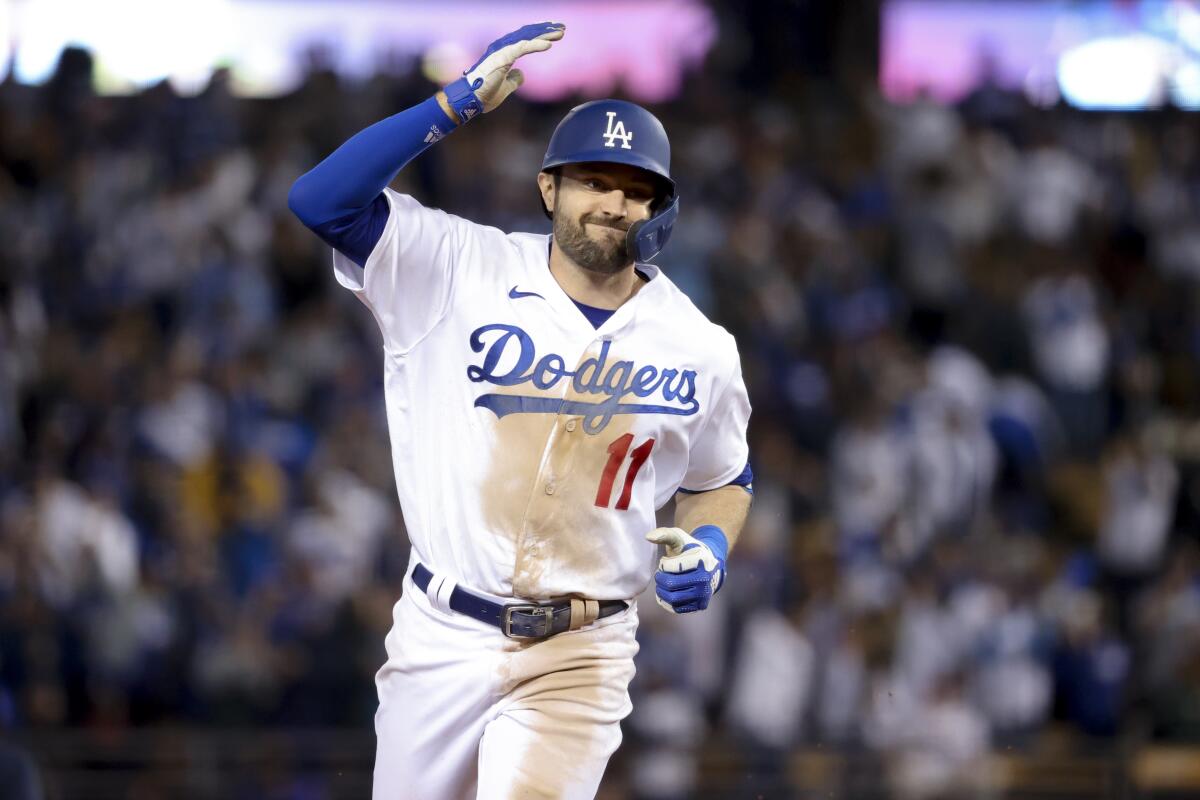 Los Angeles Dodgers' AJ Pollock rounds the bases after a three-run home run.