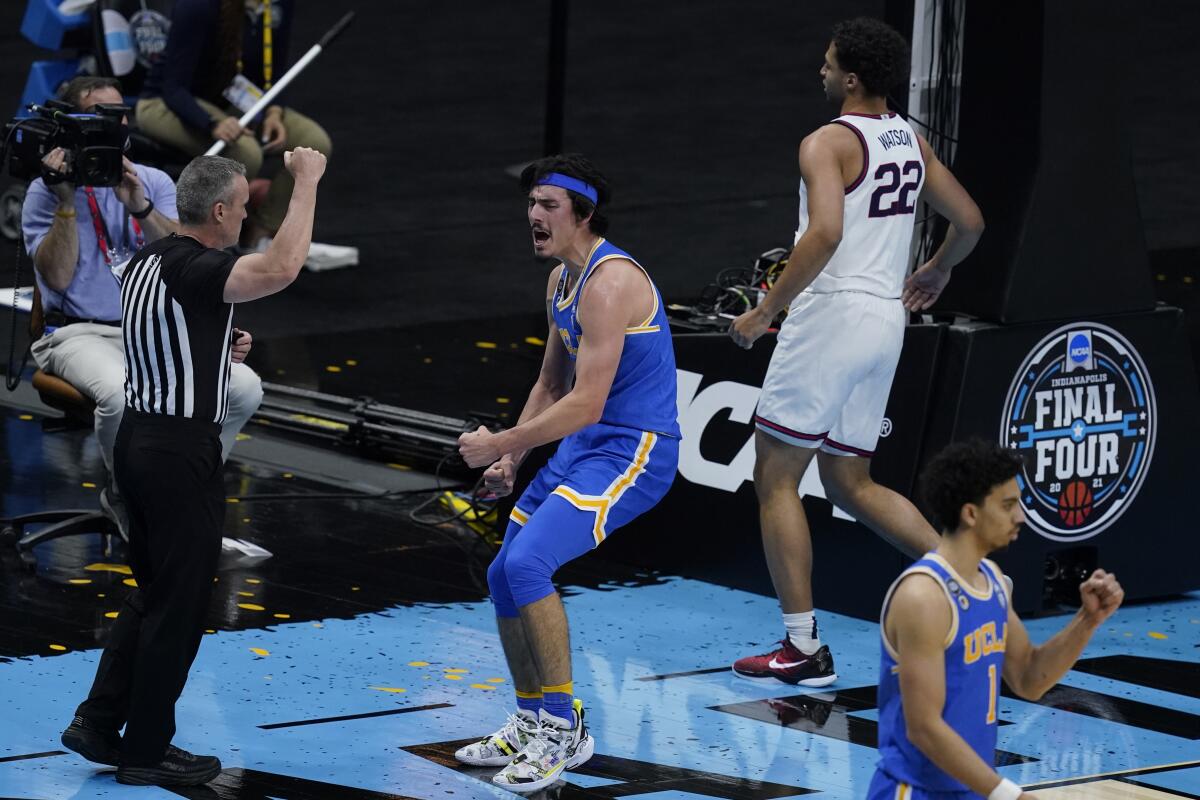 UCLA guard Jaime Jaquez Jr., center, celebrates in front of Gonzaga forward Anton Watson after making a basket.